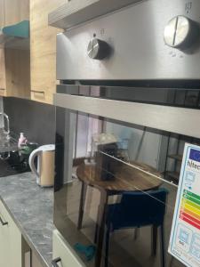 a kitchen with a counter with a table and a stove at Maisonette am Burg in Möckmühl +5 photos
