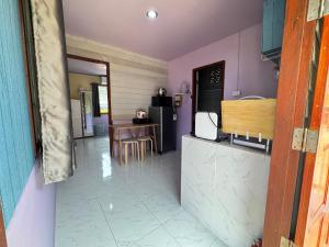 a kitchen with purple walls and a counter and a table at Serenity House 4D in Ban Ko Khwan +21 photos