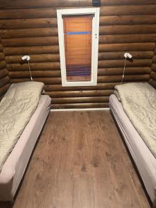 a room with two beds and a window at Øse Camping in Gratangen