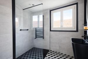 a bathroom with a shower with a glass door at Les clés du désir in Épône +20 photos