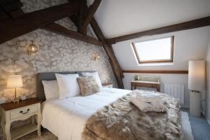 a bedroom with a large bed in a attic at Les clés du désir in Épône