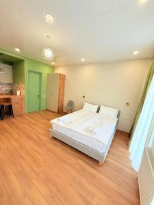 a large bedroom with a bed and a desk at Cosy City-View Flat in Mtatsminda, flat 5 in Itʼkhvisi