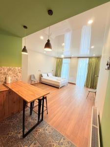 a living room with a table and a couch at Cosy City-View Flat in Mtatsminda, flat 5 in Itʼkhvisi