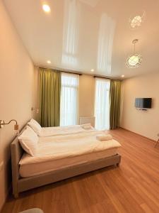 a bedroom with a large bed in a room at Cosy City-View Flat in Mtatsminda, flat 5 in Itʼkhvisi