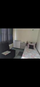 a living room with two beds and a couch at Casa com 3 quarto mobiliada in Manaus +1 photo