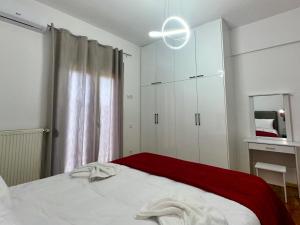 a bedroom with a bed and a white cabinet at VASKO Luxury Suites 3 in Siátista