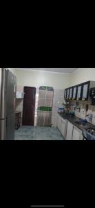 a kitchen with a refrigerator and a counter top at Casa com 3 quarto mobiliada in Manaus
