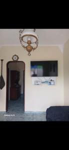 a bedroom with a chandelier and a room with a bed at Casa com 3 quarto mobiliada in Manaus