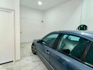 a blue car parked in a garage at VASKO Luxury Suites 3 in Siátista +9 photos