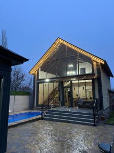 a large house with glass windows and a patio at Sultan Villas A-Frame in Quba in Quba