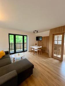 a living room with a couch and a table at Chalupa Bohunka in Kašperské Hory +15 photos