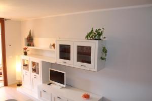 a living room with a tv and a white cabinet at AdryHouse in Grado