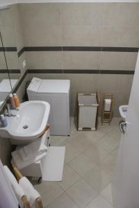 a white bathroom with a sink and a toilet at AdryHouse in Grado