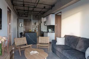 a living room with a couch and a table at Spacious 2BR 2BTH El Zonte with oceanview and pool in El Zonte