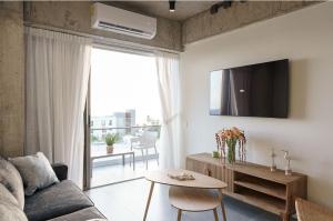 a living room with a couch and a table at Spacious 2BR 2BTH El Zonte with oceanview and pool in El Zonte