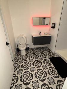 a bathroom with a toilet and a sink at Nice escape 8 min from EWR in Elizabeth