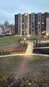 a large building with a park in front of it at Nice escape 8 min from EWR in Elizabeth
