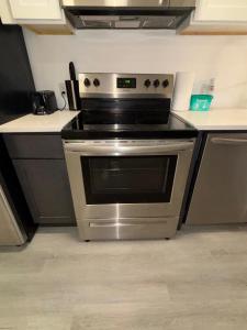 a kitchen with a stainless steel stove in a kitchen at Nice escape 8 min from EWR in Elizabeth