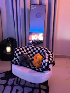 a chair with a checkered blanket and a cell phone at استوديو مميز بأثاث مريح in Al Khobar