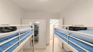 a room with two bunk beds and a mirror at HEI HEI AND PUA VILLA - heated pool, priv parking, fibre net, Palm-Mar in Palm-Mar
