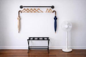 a room with a chair and umbrellas on a wall at Artsy Hidden Gem -- FREE PARKING in Philadelphia