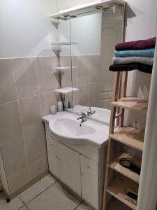 ein Badezimmer mit Waschbecken und Spiegel in der Unterkunft Le Four à Pains in Dole + 8 Fotos