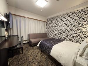 En eller flere senge i et værelse på APA Hotel Kitakami Ekinishi