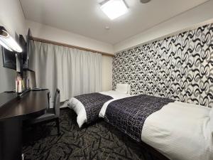 En eller flere senge i et værelse på APA Hotel Kitakami Ekinishi