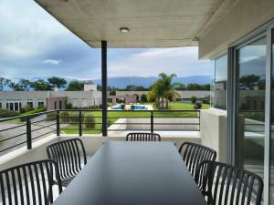 een tafel en stoelen op het balkon van een huis bij LS Apart Hotel in Martin Miguel de Güemes International Airport