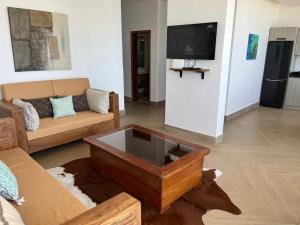 a living room with a couch and a coffee table at Villa Regia in Poponguine