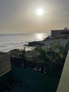 a view of the ocean from the balcony of a building at Villa Regia in Poponguine