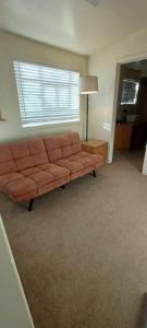 een bank in een woonkamer met een raam bij Historic Reno Home in Reno