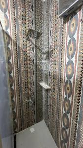 a shower in a bathroom with a shower curtain at Nuba Nest in Aswan +122 photos