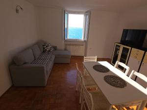 a living room with a couch and a table at Apartmaji Trije Valovi in Piran