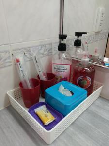 a white basket with toothbrushes and other items in a bathroom at Mary Apt @ Equatorial Hill Resort in Cameron Highlands