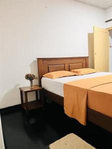 a bedroom with two beds and a side table at location weligama in Weligama