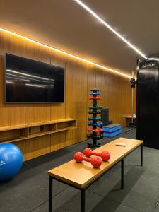 a room with a table with boxing gloves on it at Flat Pé na areia com Banheira Privativa in João Pessoa