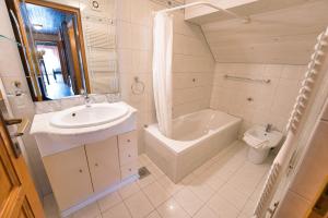 a bathroom with a sink and a tub and a toilet at Pr Bevc in Bled +34 photos