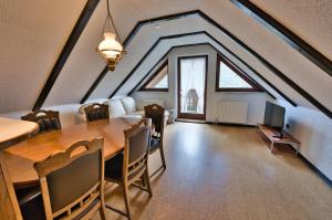 a dining room with a table and chairs in a attic at Pr Bevc in Bled