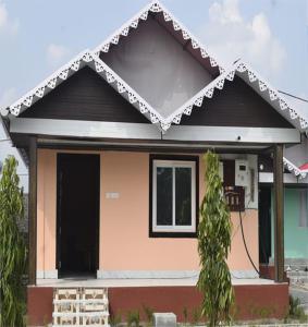 a small house with a black roof at Pine Apple Resorts in Jalpāiguri