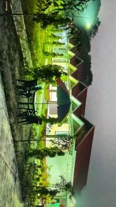 a reflection of a building in the water at Pine Apple Resorts in Jalpāiguri