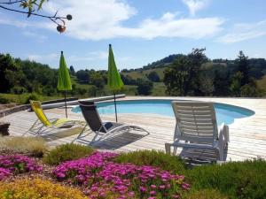 three chairs and umbrellas next to a swimming pool at Le gîte Bellevue in Firmi +19 photos