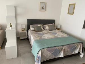 una camera da letto con un letto in una stanza bianca di Beachfront apartment a Marigot Altre 13 foto