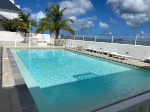 a large swimming pool on the side of a building at Beachfront apartment in Marigot