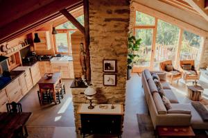 a living room and kitchen in a log cabin at Espectacular Chalet de Montaña Pirineos, Burg in Burg