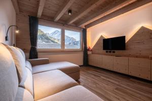 a living room with a couch and a flat screen tv at - Piz Boe - Canazei center app. in Canazei