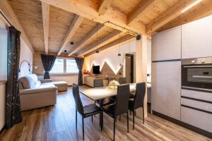 a kitchen and living room with a table and chairs at - Piz Boe - Canazei center app. in Canazei