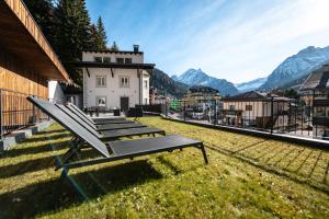 a group of benches sitting on the side of a building at - Piz Boe - Canazei center app. in Canazei