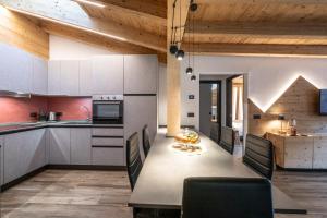 a kitchen and dining room with a table and chairs at - Punta Penia - Canazei center app in Canazei
