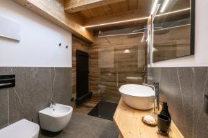 a bathroom with a white toilet and a sink at - Punta Penia - Canazei center app in Canazei +20 photos
